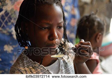"Girl, 9 years, eating soup in a shack, Camp Icare for earthquake refugees, Fort National, Port-au-Prince, Haiti, North America" View Large Photo Image Picture - "Girl, 9 years, eating soup in a shack, Camp Icare for earthquake refugees, Fort National, Port-au-Prince, Haiti, North America". Fotosearch