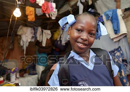 Stock Photograph - "Girl, 9 years, in school uniform, Camp Icare for earthquake refugees, Fort National, Port-au-Prince, Haiti, North America". Fotosearch