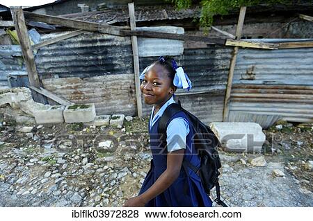 Stock Photo - "Girl, 9 years, on her way to school, Camp Icare for earthquake refugees, Fort National, Port-au-Prince, Haiti, North America". Fotosearch