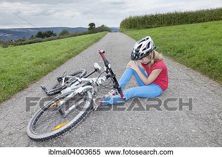 "Girl, 9 years, wearing a bicycle helmet, holding her knee after crashing with her bicycle" View Large Photo Image Stock Photography - "Girl, 9 years, wearing a bicycle helmet, holding her knee after crashing with her bicycle". Fotosearch