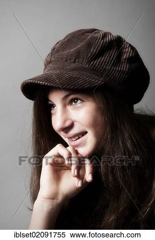 Stock Photography - "Girl, aged 13, wearing a brown cap, smiling, portrait". Fotosearch