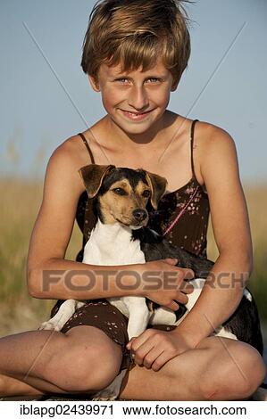 Stock Image - Girl and a Dansk-Svensk Gardshund or Danish-Swedish Farmdog. Fotosearch