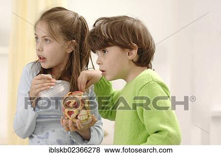 Girl and boy nibbling on Christmas cookies View Large Photo Image Stock Photo - Girl and boy nibbling on Christmas cookies. Fotosearch