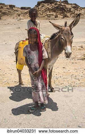 "Girl and boy with a donkey on the way to a waterhole, in the lowlands, Eritrea, Africa" View Large Photo Image Stock Image - "Girl and boy with a donkey on the way to a waterhole, in the lowlands, Eritrea, Africa". Fotosearch