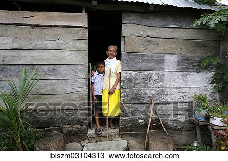 "Girl and elderly woman standing at the entrance of her hut in a poor village, Chanero Rio, Provinz Jonuta, Tabasco, Mexico, North America" View Large Photo Image Stock Image - "Girl and elderly woman standing at the entrance of her hut in a poor village, Chanero Rio, Provinz Jonuta, Tabasco, Mexico, North America". Fotosearch