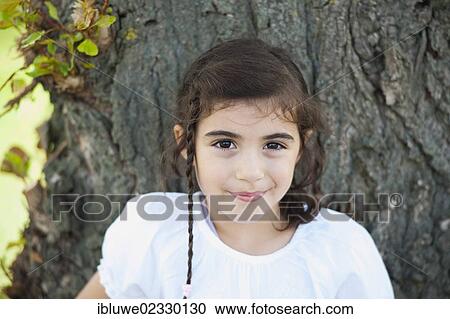 Stock Image - "Girl at a tree, portrait". Fotosearch