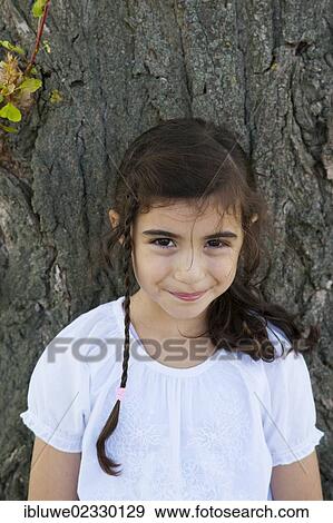 "Girl at a tree, portrait" View Large Photo Image Stock Photo - "Girl at a tree, portrait". Fotosearch