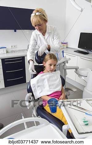 "Girl at the dentist, dental assistant preparing the patient, Germany, Europe" View Large Photo Image Stock Photo - "Girl at the dentist, dental assistant preparing the patient, Germany, Europe". Fotosearch