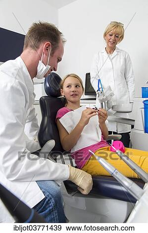 "Girl at the dentist, dentist discussing further treatment with the patient, Germany, Europe" View Large Photo Image Stock Photo - "Girl at the dentist, dentist discussing further treatment with the patient, Germany, Europe". Fotosearch