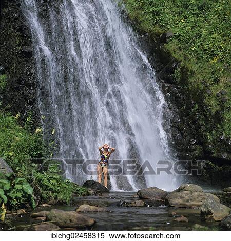 Stock Photography - "Girl bathing in a waterfall, Parc Naturel Regional des Volcans d'Auvergne, Natural regional park of Volcans d'Auvergne, Puy de Dome, Auvergne, France, Europe". Fotosearch