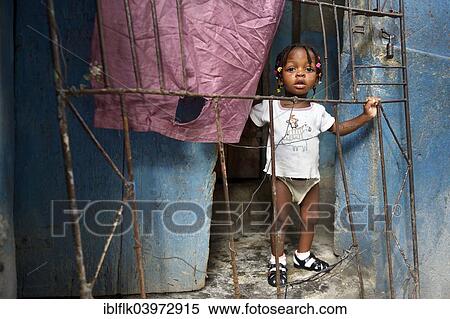 "Girl behind a fence in a doorway, Fort National slum, Port-au-Prince, Haiti, North America" View Large Photo Image Stock Photography - "Girl behind a fence in a doorway, Fort National slum, Port-au-Prince, Haiti, North America". Fotosearch