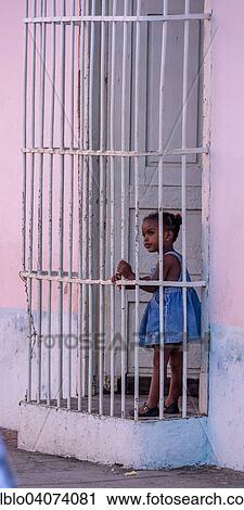 "Girl behind window bars in a pink house, Trinidad, Sancti Spiritus Province, Cuba, North America" View Large Photo Image Stock Image - "Girl behind window bars in a pink house, Trinidad, Sancti Spiritus Province, Cuba, North America". Fotosearch