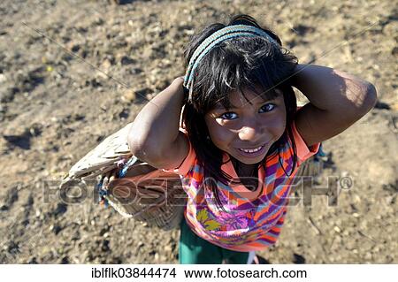 "Girl carrying a traditional basket on her back in a village of the Xavantes people, Nova Vida near the mission of Sangradouro, Primavera do Leste, Mato Grosso, Brazil, South America" View Large Photo Image Picture - "Girl carrying a traditional basket on her back in a village of the Xavantes people, Nova Vida near the mission of Sangradouro, Primavera do Leste, Mato Grosso, Brazil, South America". Fotosearch