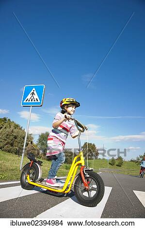Girl crossing a zebra crossing with her scooter View Large Photo Image Picture - Girl crossing a zebra crossing with her scooter. Fotosearch