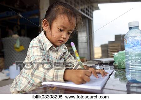Stock Photography - "Girl doing her homework, Trapang Village, Bathi District, Takeo Province, Cambodia, Asia". Fotosearch