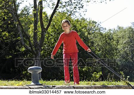 "Girl fastening a rope to secure the boat in the lock chamber, houseboat on the Canal des Vosges, formerly Canal de l'Est, at Lock 15, PK 106, Uzemain, Epinal, Lorraine, Departement Vosges, France, Europe" View Large Photo Image Stock Photo - "Girl fastening a rope to secure the boat in the lock chamber, houseboat on the Canal des Vosges, formerly Canal de l'Est, at Lock 15, PK 106, Uzemain, Epinal, Lorraine, Departement Vosges, France, Europe". Fotosearch