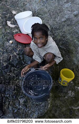 "Girl fetching water at a spring, Tchawa, Leogane, Haiti, North America" View Large Photo Image Stock Image - "Girl fetching water at a spring, Tchawa, Leogane, Haiti, North America". Fotosearch