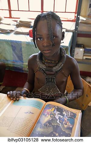 "Girl, Himba pupil, sitting in a classroom at the Omohanga Primary School, Himba school, Omohanga, Kaokoland, Kunene, Namibia, Africa" View Large Photo Image Stock Photo - "Girl, Himba pupil, sitting in a classroom at the Omohanga Primary School, Himba school, Omohanga, Kaokoland, Kunene, Namibia, Africa". Fotosearch