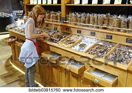 Stock Image - "Girl in the Maison George Larnicol chocolate shop, Montmartre, Paris, France, Europe". Fotosearch