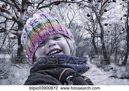 "Girl in winter clothing, in front of trees with Christmas baubles" View Large Photo Image Stock Image - "Girl in winter clothing, in front of trees with Christmas baubles". Fotosearch