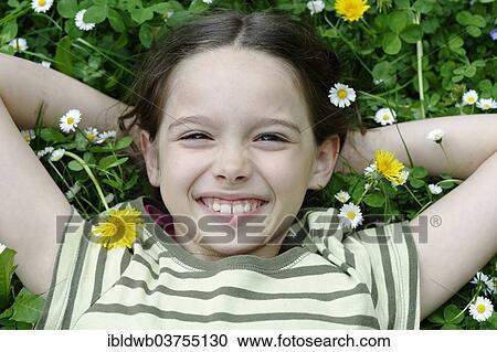 "Girl lying on a flower meadow, Upper Bavaria, Bavaria, Germany, Europe" View Large Photo Image Stock Image - "Girl lying on a flower meadow, Upper Bavaria, Bavaria, Germany, Europe". Fotosearch