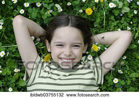 "Girl lying on a flower meadow, Upper Bavaria, Bavaria, Germany, Europe" View Large Photo Image Stock Image - "Girl lying on a flower meadow, Upper Bavaria, Bavaria, Germany, Europe". Fotosearch