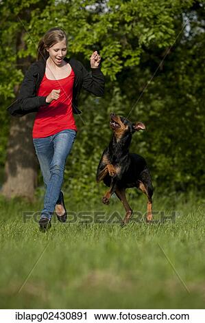 Girl playing with a Doberman View Large Photo Image Stock Image - Girl playing with a Doberman. Fotosearch