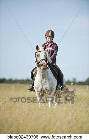 Girl riding a pony in dunes View Large Photo Image Stock Photograph - Girl riding a pony in dunes. Fotosearch