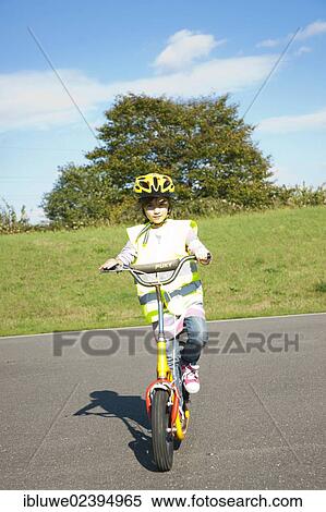 Stock Photography - Girl riding a scooter. Fotosearch