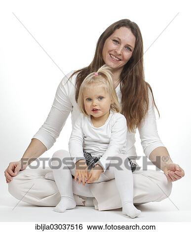 Girl sitting on lap of a woman sitting cross-legged View Large Photo Image Stock Photograph - Girl sitting on lap of a woman sitting cross-legged. Fotosearch