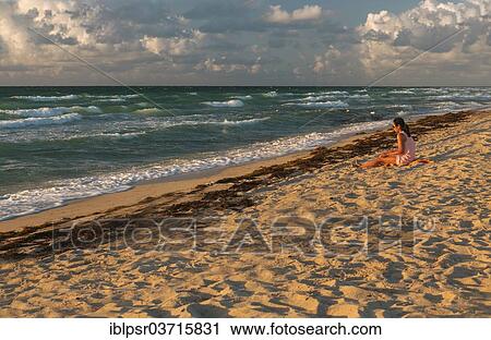 "Girl sitting on the beach in the morning light, Miami Beach, Miami-Dade County, Florida, United States, North America" View Large Photo Image Stock Image - "Girl sitting on the beach in the morning light, Miami Beach, Miami-Dade County, Florida, United States, North America". Fotosearch