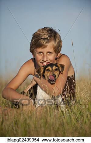Girl sitting with a Dansk-Svensk Gardshund or Danish Swedish Farmdog in a meadow View Large Photo Image Picture - Girl sitting with a Dansk-Svensk Gardshund or Danish Swedish Farmdog in a meadow. Fotosearch