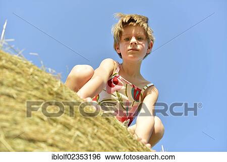 "Girl, six years, with glasses, on a straw bale, Germany, Europe" View Large Photo Image Stock Photograph - "Girl, six years, with glasses, on a straw bale, Germany, Europe". Fotosearch