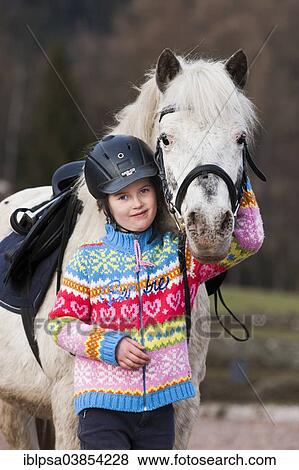 "Girl standing beside a pony, gray, Tyrol, Austria, Europe" View Large Photo Image Stock Photo - "Girl standing beside a pony, gray, Tyrol, Austria, Europe". Fotosearch
