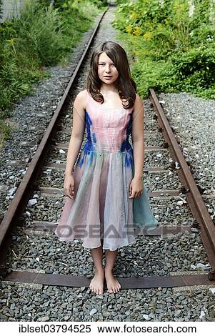 Girl standing on a railroad track View Large Photo Image Stock Photography - Girl standing on a railroad track. Fotosearch