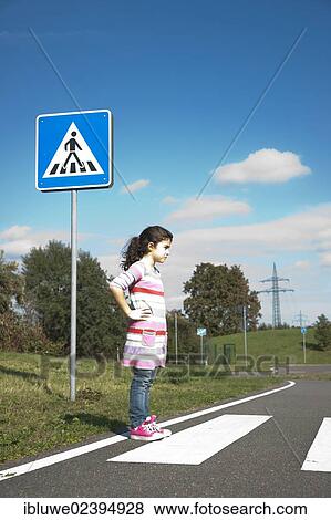 Girl waiting at a zebra crossing View Large Photo Image Stock Photo - Girl waiting at a zebra crossing. Fotosearch