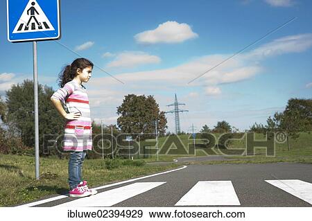 Girl waiting at a zebra crossing View Large Photo Image Stock Photo - Girl waiting at a zebra crossing. Fotosearch