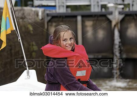 "Girl wearing a life vest in a lock chamber of a rising lock, houseboat on the Canal des Vosges, formerly Canal de l'Est, Fontenoy-le-Chateau, Epinal, Lorraine, Departement Vosges, France, Europe" View Large Photo Image Picture - "Girl wearing a life vest in a lock chamber of a rising lock, houseboat on the Canal des Vosges, formerly Canal de l'Est, Fontenoy-le-Chateau, Epinal, Lorraine, Departement Vosges, France, Europe". Fotosearch