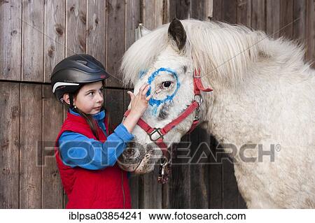 "Girl wearing a riding helmet painting a pony with finger paints, gray, Tyrol, Austria, Europe" View Large Photo Image Stock Image - "Girl wearing a riding helmet painting a pony with finger paints, gray, Tyrol, Austria, Europe". Fotosearch