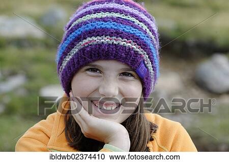 Stock Image - "Girl wearing a wool cap, portrait". Fotosearch