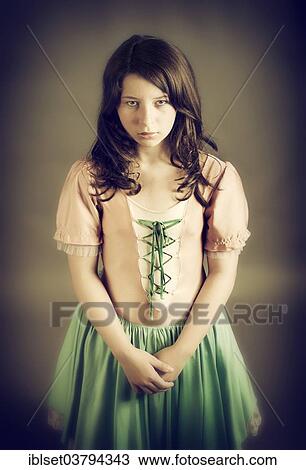 Girl wearing an old-fashioned dress looking sad View Large Photo Image Stock Image - Girl wearing an old-fashioned dress looking sad. Fotosearch
