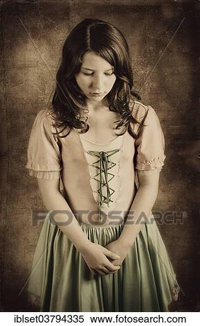 Girl wearing an old-fashioned dress looking sad View Large Photo Image Stock Photography - Girl wearing an old-fashioned dress looking sad. Fotosearch