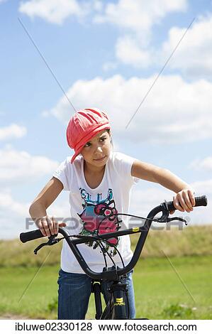 Stock Photo - Girl with a BMX bike. Fotosearch