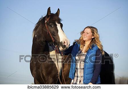 "Girl with a Paint Horse, brown tobiano, gelding, bridled" View Large Photo Image Stock Photo - "Girl with a Paint Horse, brown tobiano, gelding, bridled". Fotosearch