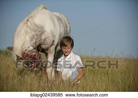 Girl with a pony in a meadow View Large Photo Image Stock Photography - Girl with a pony in a meadow. Fotosearch