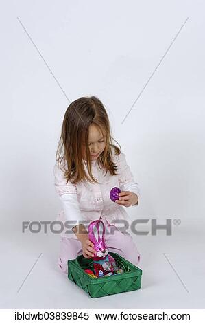 Girl with an Easter basket and a chocolate Easter bunny View Large Photo Image Stock Photography - Girl with an Easter basket and a chocolate Easter bunny. Fotosearch