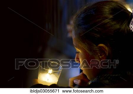"Girl with candle, in prayer, Germany, Europe" View Large Photo Image Stock Image - "Girl with candle, in prayer, Germany, Europe". Fotosearch