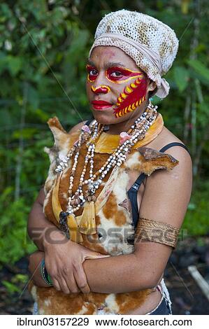 "Girl with colourful decorations and face paint is celebrating at the traditional Sing Sing gathering in the Highlands, Paya, Papua New Guinea, Oceania" View Large Photo Image Stock Photo - "Girl with colourful decorations and face paint is celebrating at the traditional Sing Sing gathering in the Highlands, Paya, Papua New Guinea, Oceania". Fotosearch