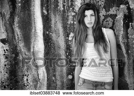 "Girl with long hair, 15 years, standing in front of an old weathered wall" View Large Photo Image Stock Photo - "Girl with long hair, 15 years, standing in front of an old weathered wall". Fotosearch