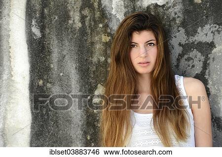 "Girl with long hair, 15 years, standing in front of an old weathered wall, portrait" View Large Photo Image Stock Photograph - "Girl with long hair, 15 years, standing in front of an old weathered wall, portrait". Fotosearch